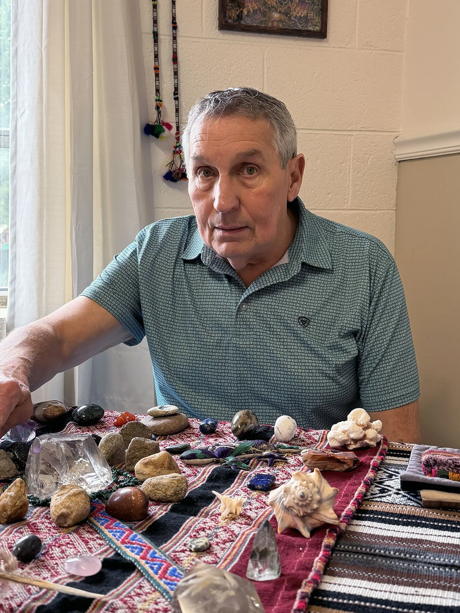 Roger Wheelock performing a shamanic healing session with stones and cloth on a table