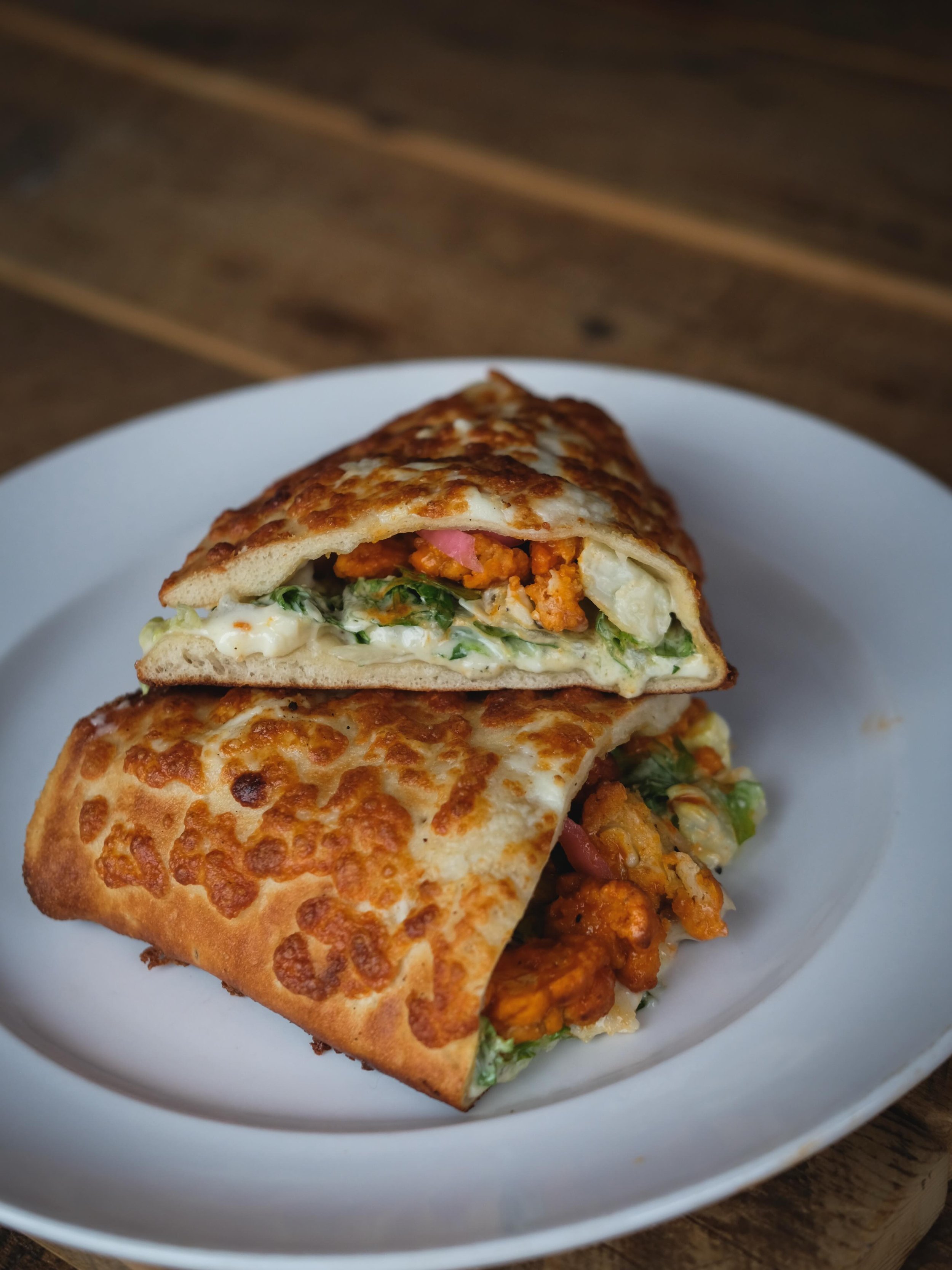 New for Spring! Our Buffalo Chicken Sal-Zone. 

Our beer dough folded and baked with a three-cheese blend. Stuffed with chilled Caesar salad and hot buffalo chicken tenders with a drizzle of bleu cheese dressing.

Yes, it is amazingly delicious. Grab