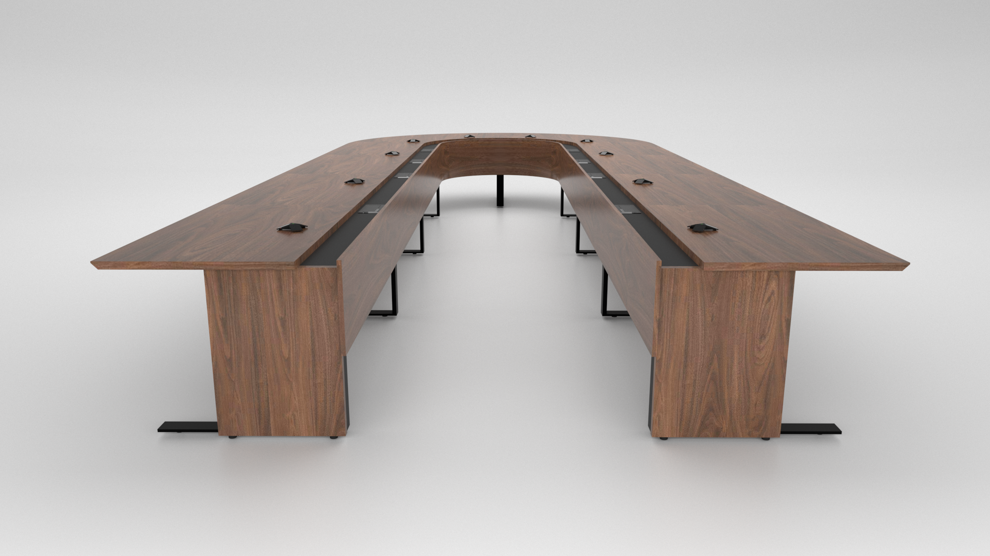 Cornerstone Furniture built a custom boardroom table for a U.S. Army base in Germany. Featuring a U-shaped design in walnut veneer, a lowered power and data trough, modesty panels, and custom bases with wire management access for clean functionality.