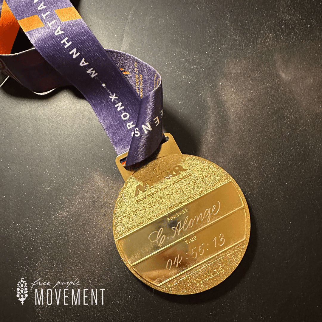 Hand-engraved NYC Marathon race medal with runner's name and run time