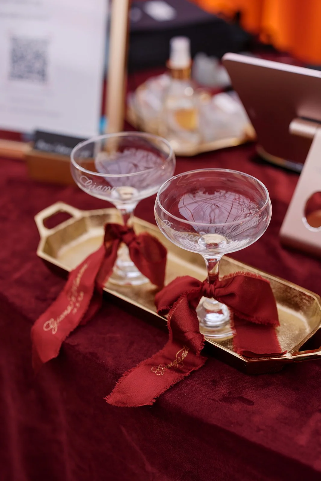 Decorative gold-framed mirror leaning against a window with handwritten message and a vase of white flowers on the windowsill.