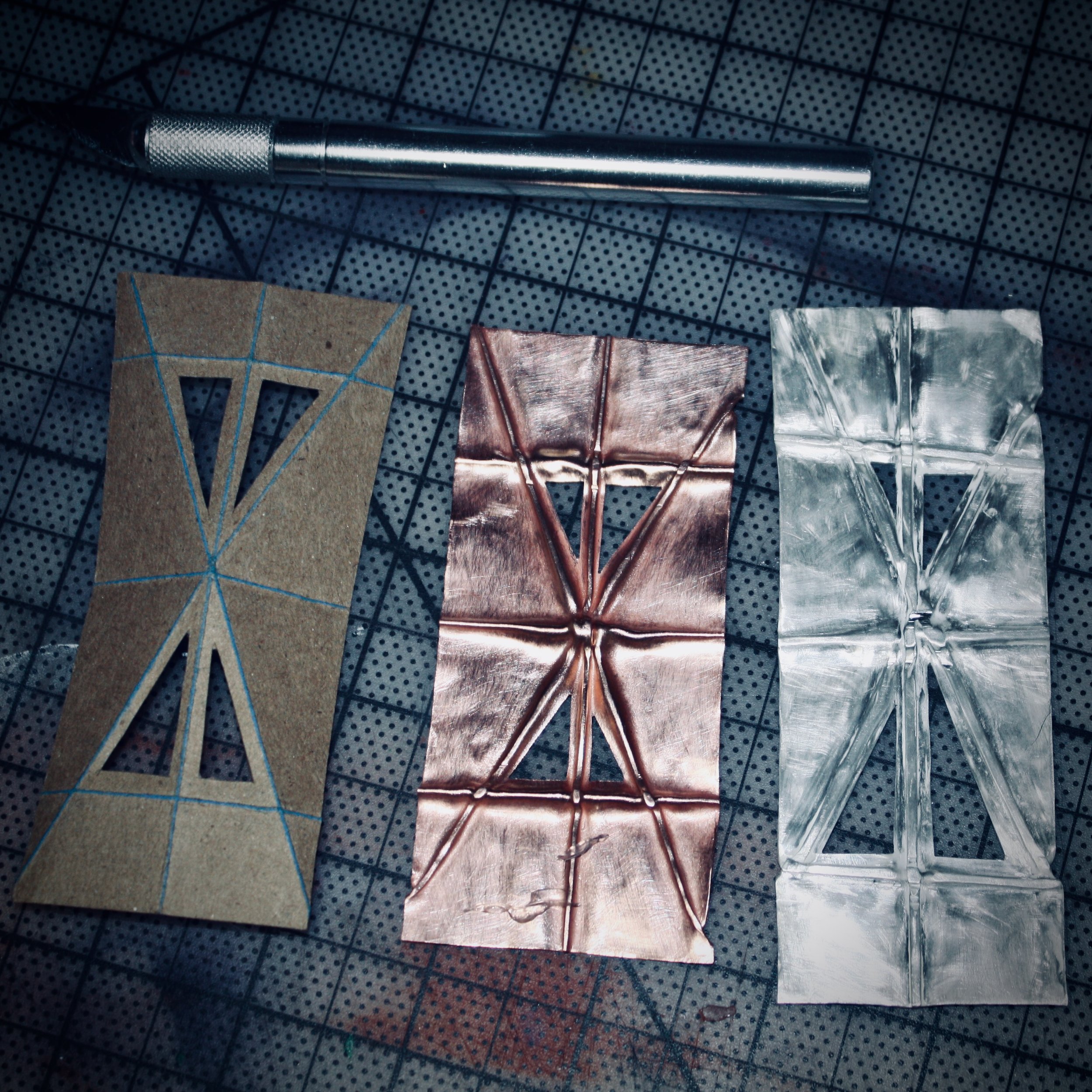 Paper template with copper and sterling silver Foldforming samples demonstrating Charles Lewton-Brain's metal-forming techniques during my early metalsmithing studies.