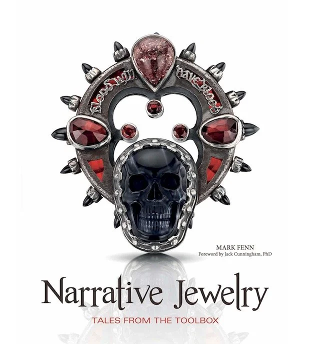 Cover of Narrative Jewelry: Tales from the Toolbox by Mark Fenn, featuring a dramatic contemporary brooch with a black skull, red gemstones, and spiked metal details.