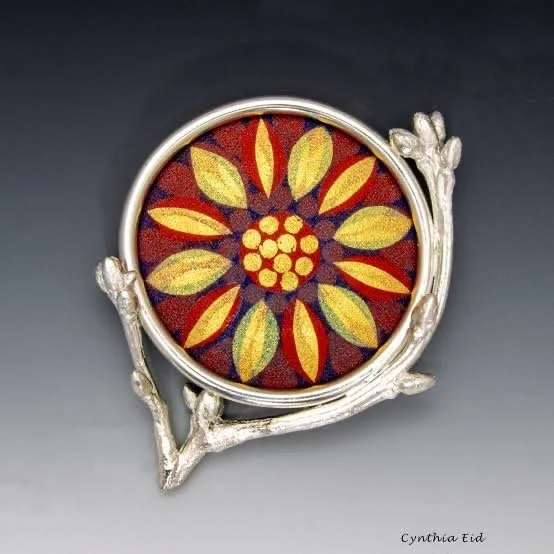 Cynthia Eid brooch featuring a colorful floral enamel centerpiece framed by sculptural sterling silver branches.