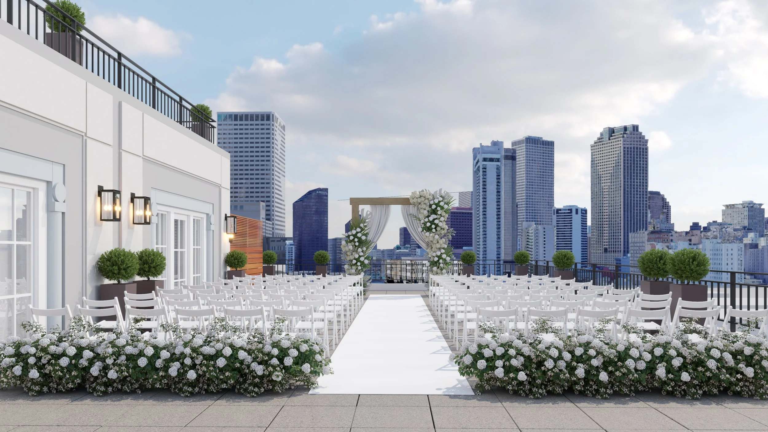 Wedding ceremony setup on a rooftop with a city skyline. White chairs arranged in rows, floral arrangements on either side of a white aisle leading to a decorated archway with white drapery and flowers.