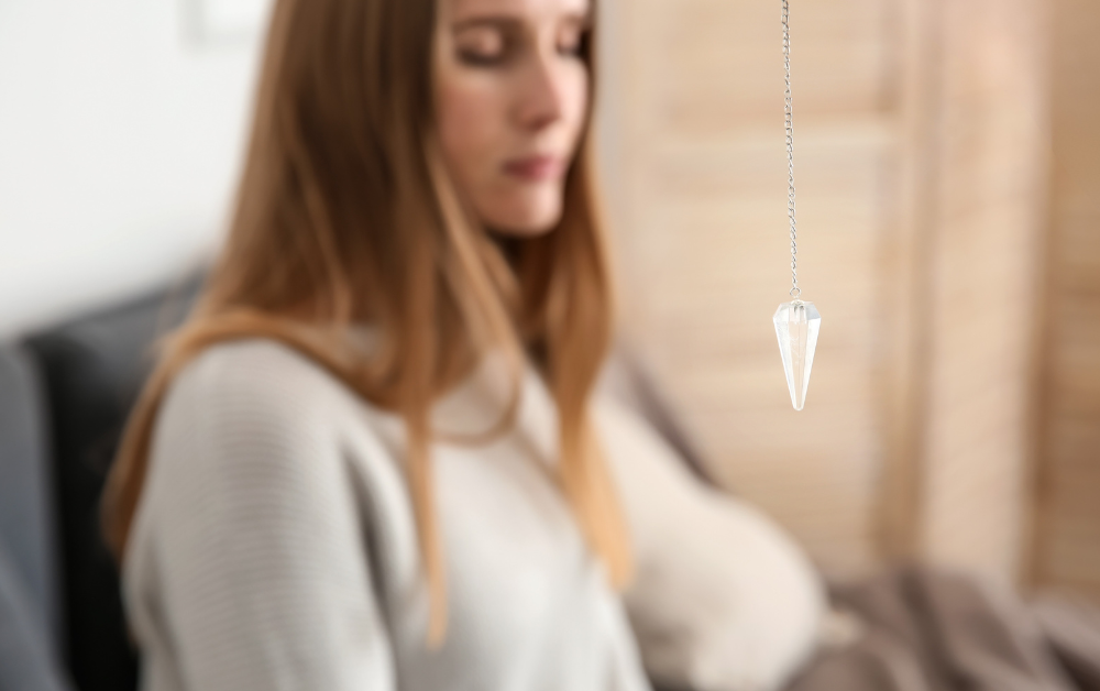 Woman with eyes closed near pendulum