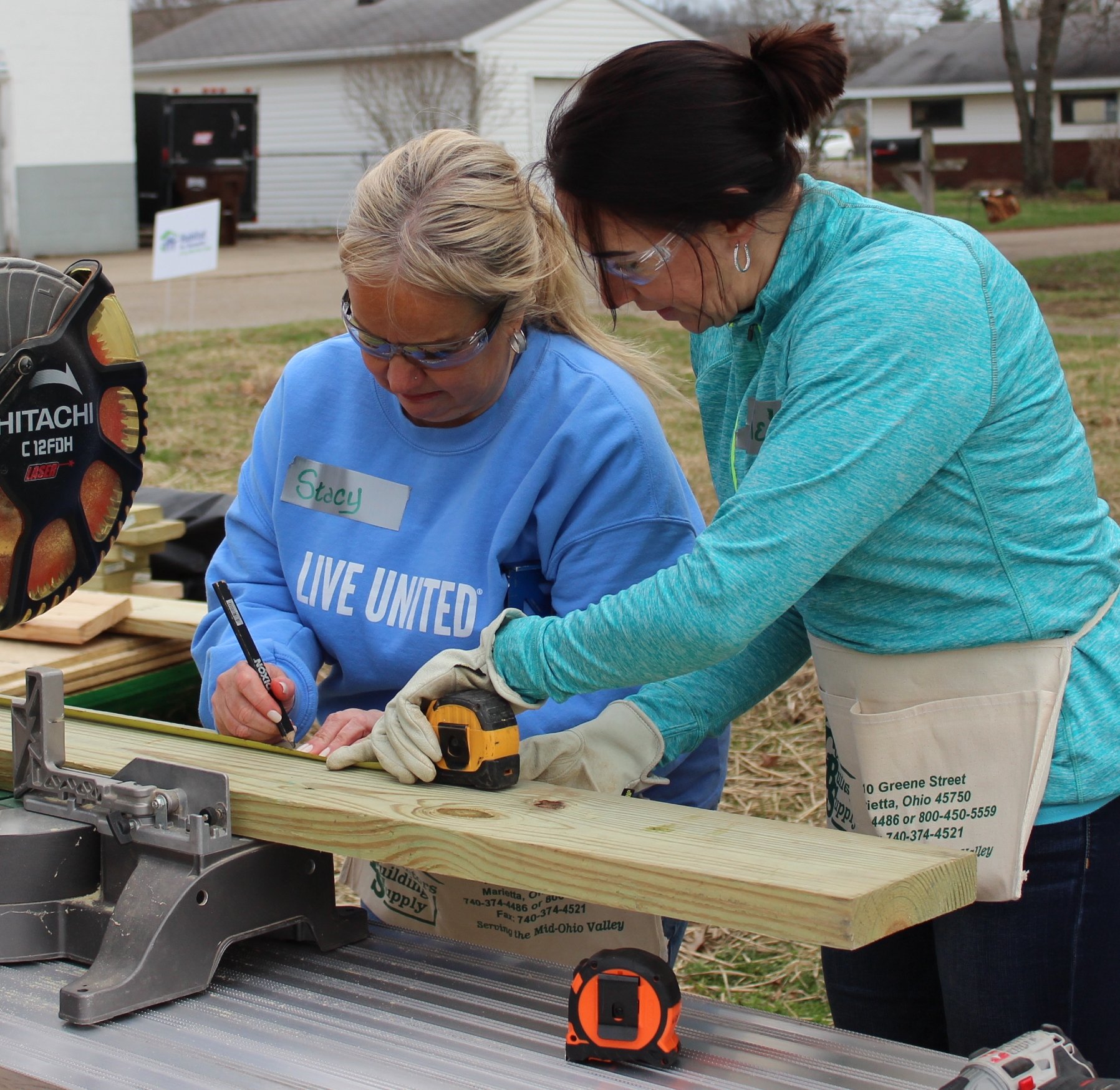 Women Build volunteers cutting 2x4's to use on a shed build