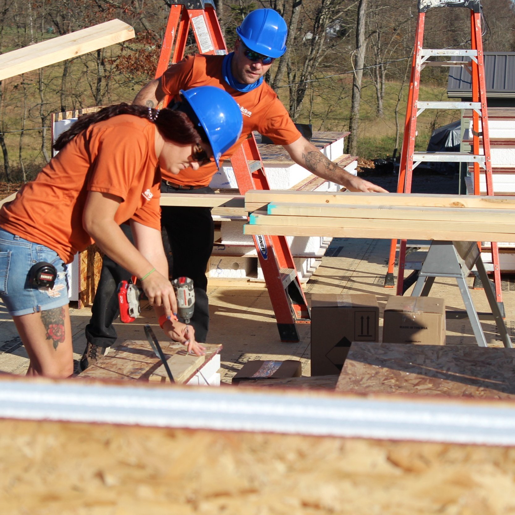 ReStore volunteers prepping wall panels for installation