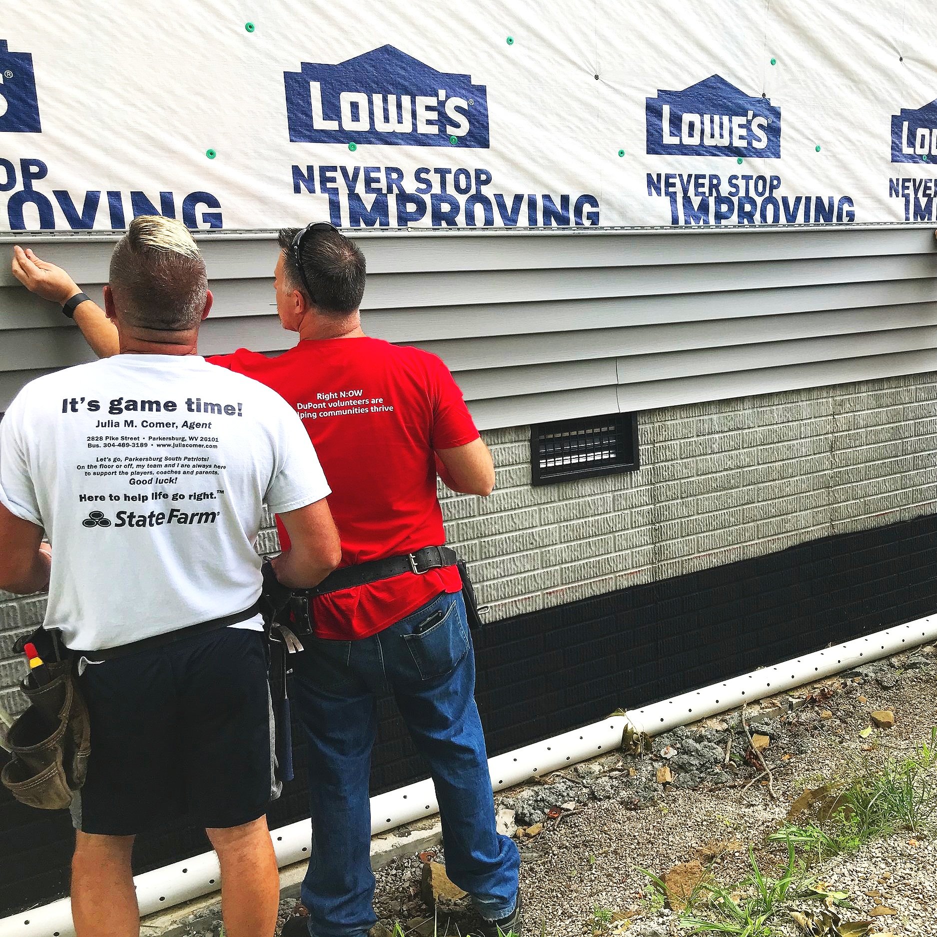 DuPont volunteers installing siding