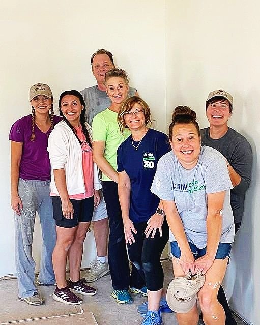 Copper Leaf Interior Designs volunteer crew painting the interior of a home