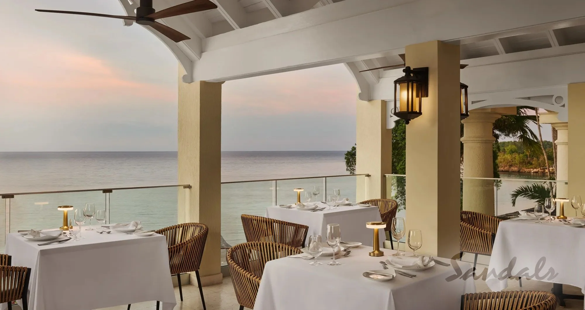 Enjoy elegant ocean views, while dining when staying at Sandals Royal Plantation when you book Deluxe Destinations LLC