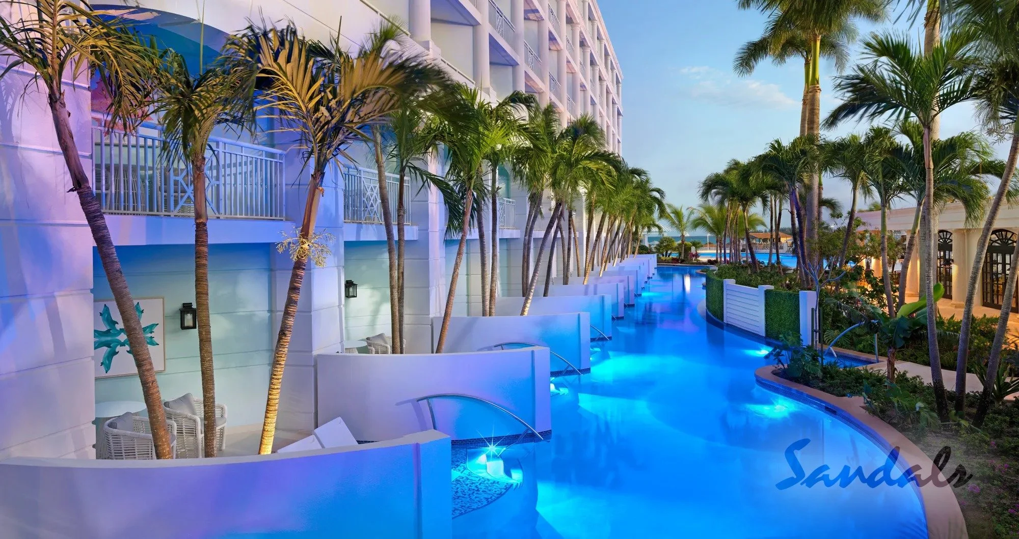 Swim-up Butler suites at Sandlas Royal Bahamian.  Lush Palm trees offer shade to resort guest who stay in the swim-up suite.