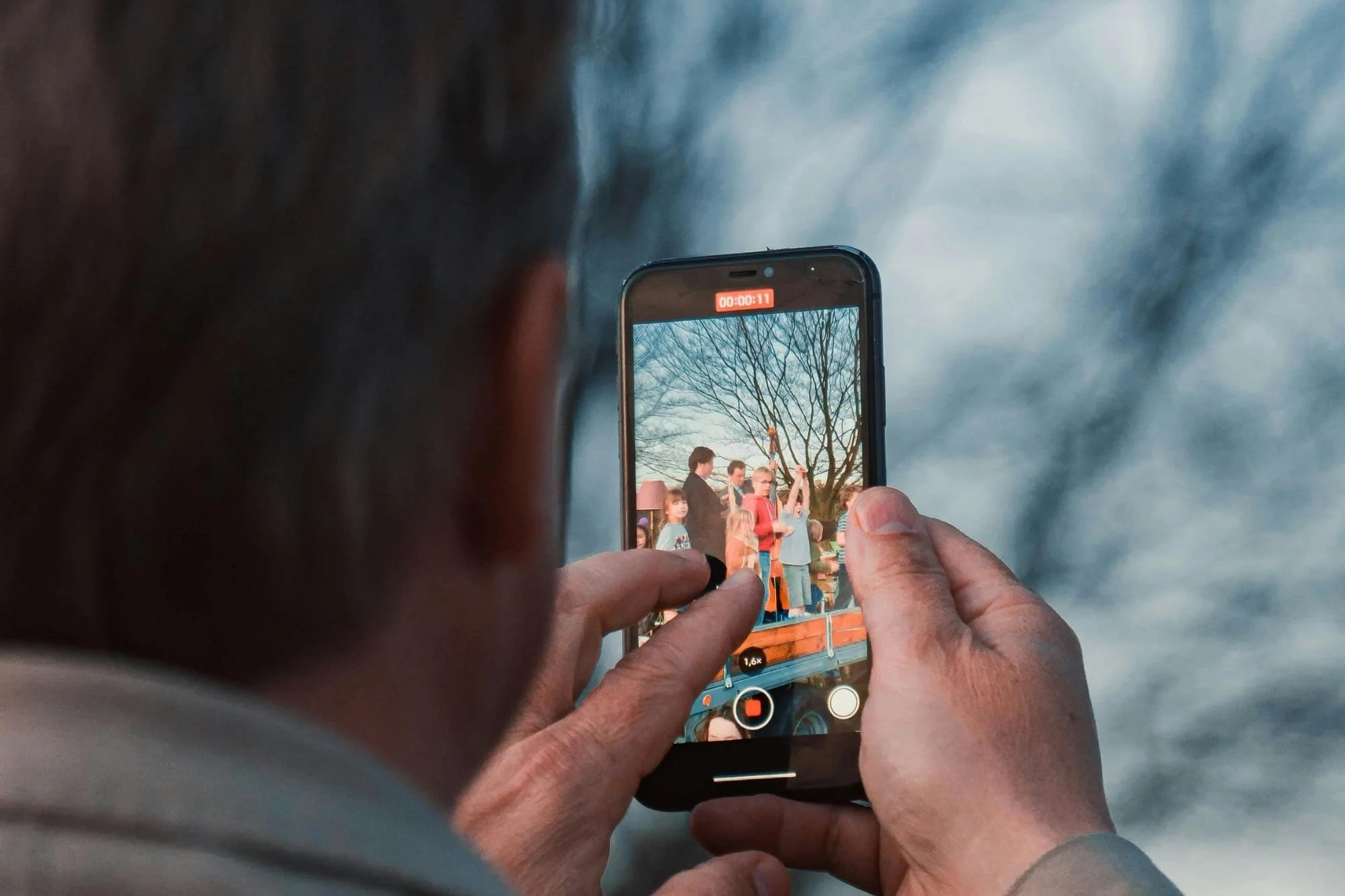 guest filming wedding moments on a smartphone at reception