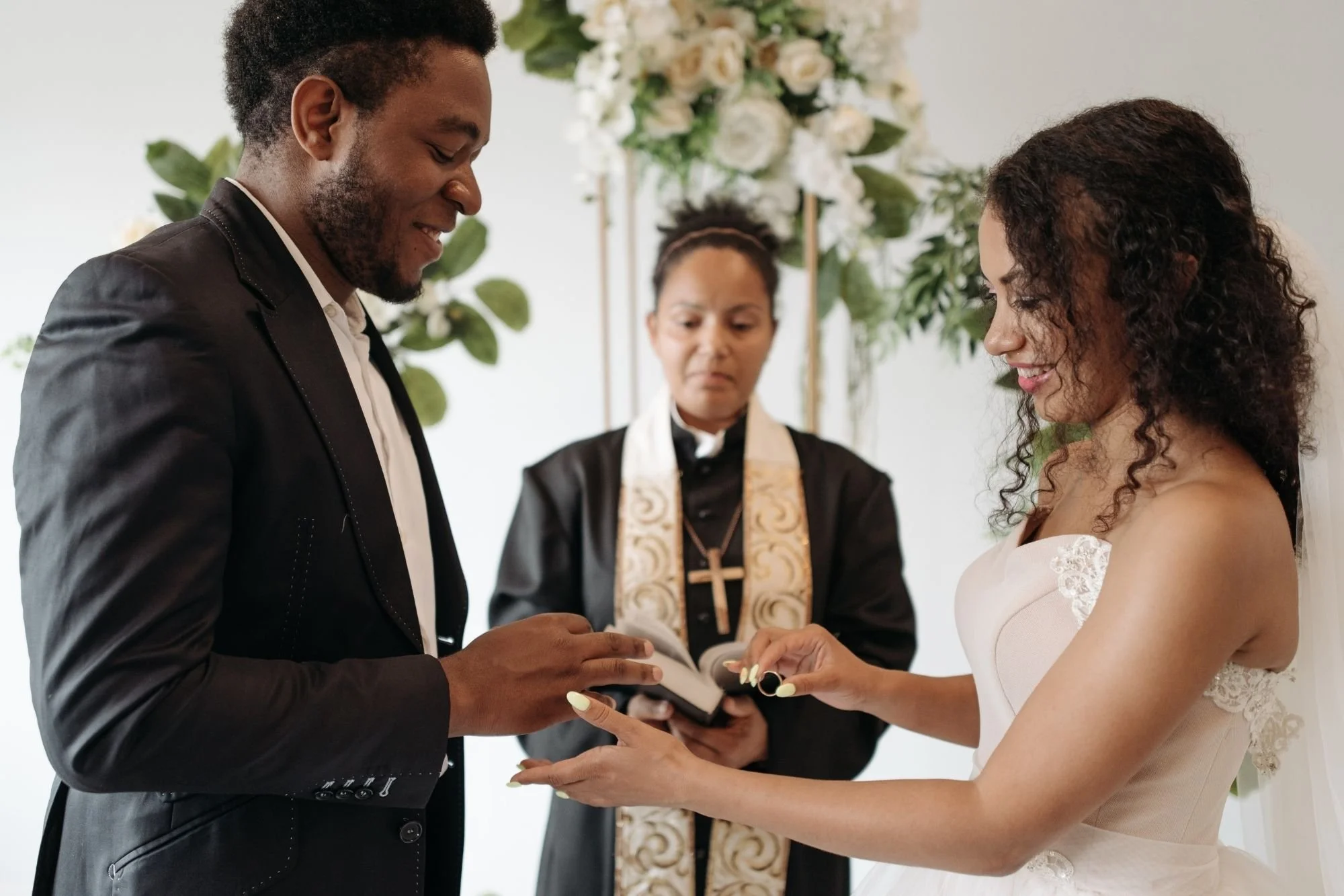 wedding-officiant-exchanging-rings-indoor-altar.jpg