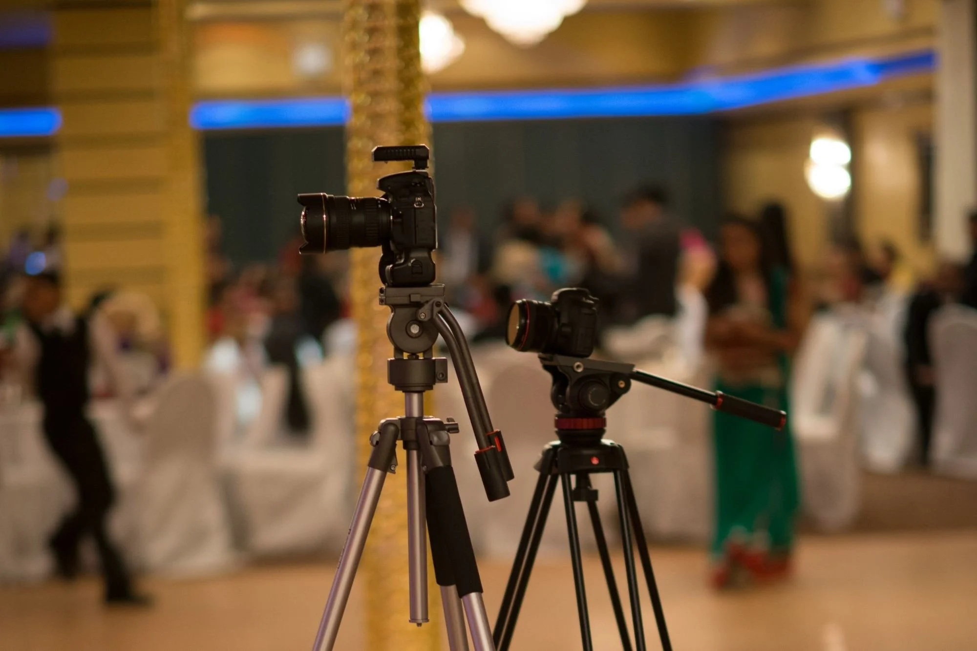 two cameras on tripods set for a ballroom wedding ceremony