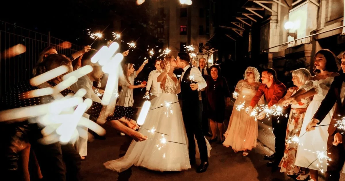 Perfect Harmony DJ at a wedding as the bride and groom kiss during a sparkler exit