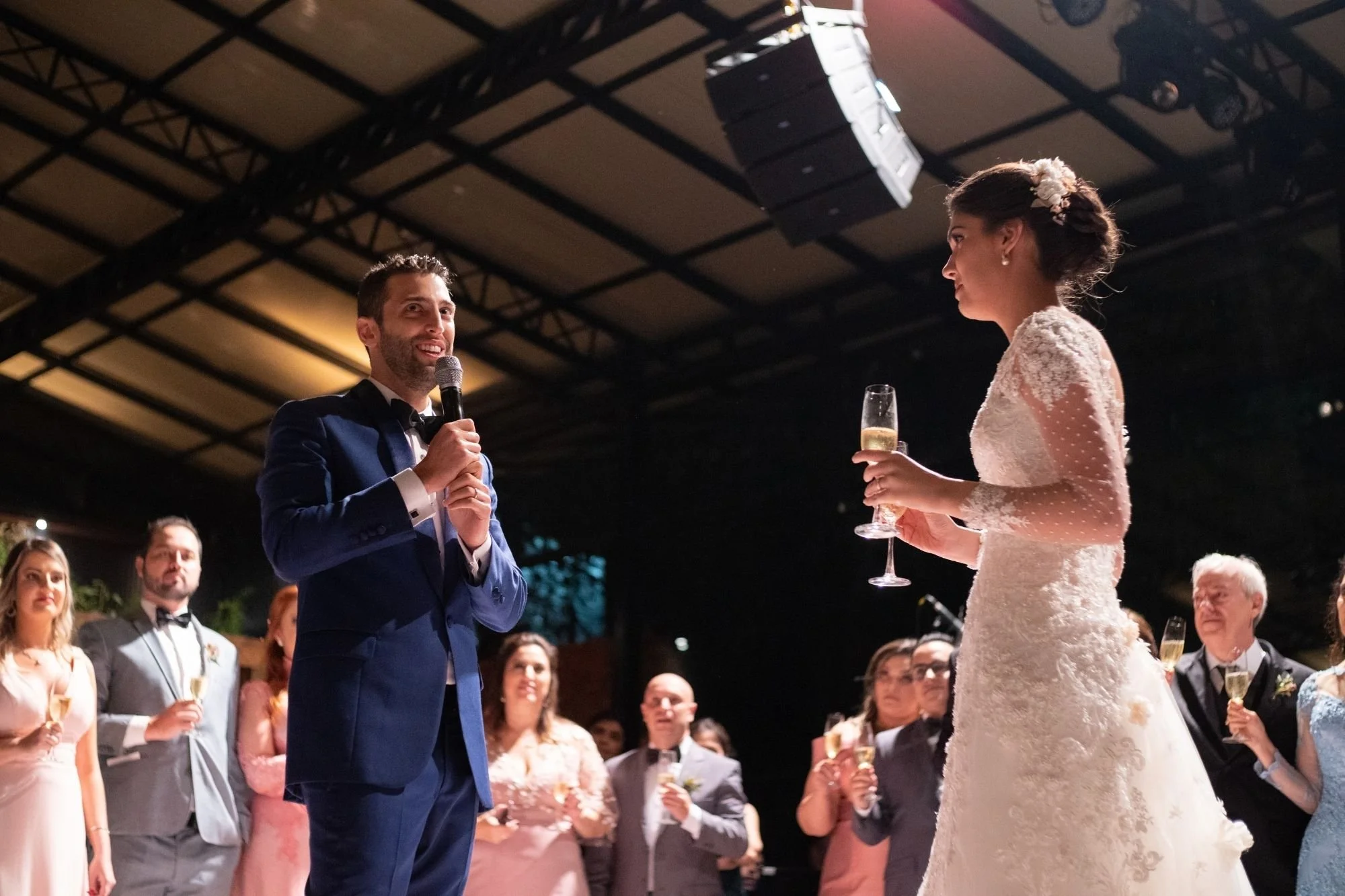 groom giving wedding toast with microphone during reception