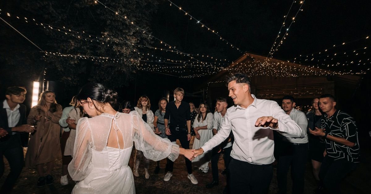 Perfect Harmony DJ at a wedding reception with guests dancing.