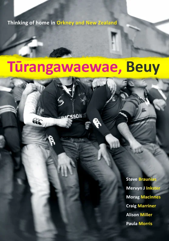Black and white photo of rugby players standing side by side, with a large yellow banner across their faces. The text on the banner reads 'Tūrangaewawe, Beuy'. Additional text states 'Thinking of home in Orkey and New Zealand' and lists names of individuals.