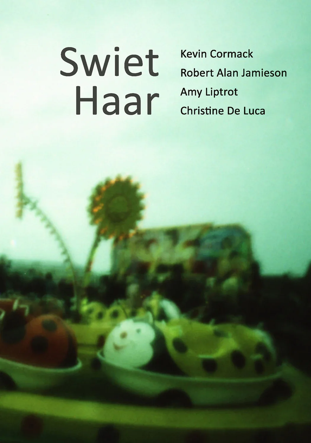 Book cover with green background, titled 'Swiêt Haar' by Kevin Cormack, Robert Alan Jamieson, Amy Liptrot, and Christine De Luca. In the foreground, decorative ladybug figurines on a tray, with a sunflower in the background.