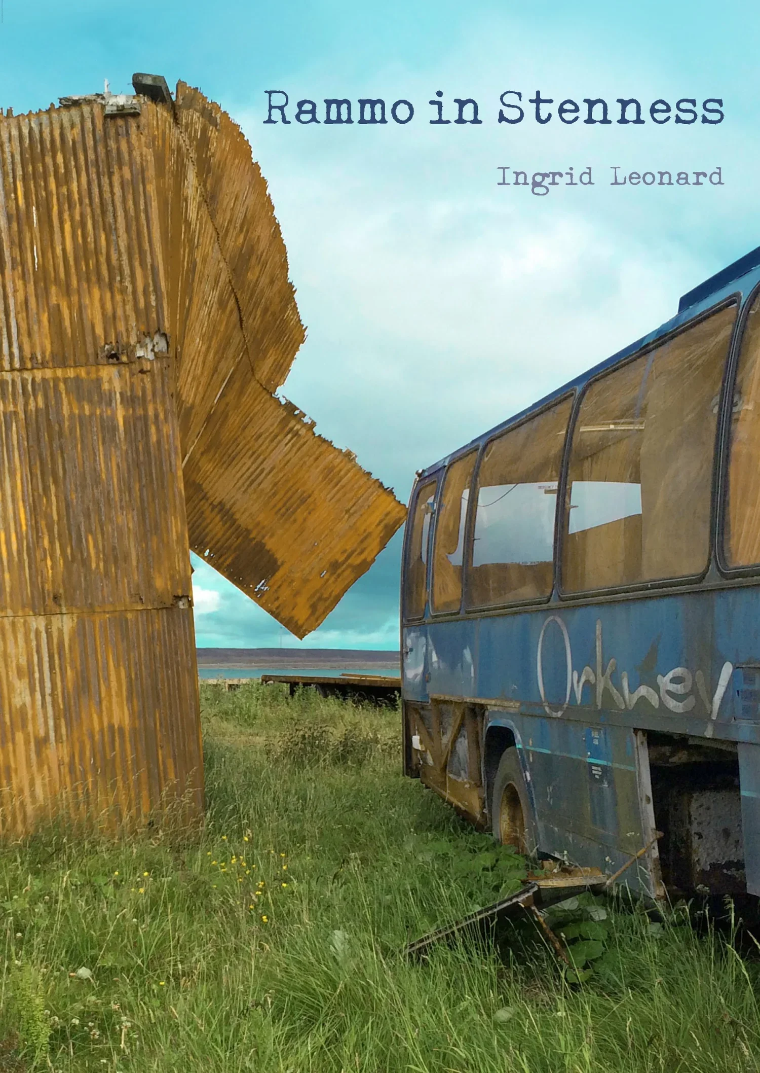 A rusty, weathered bus near a grassy field with a wooden sculpture and a blue sky in the background.