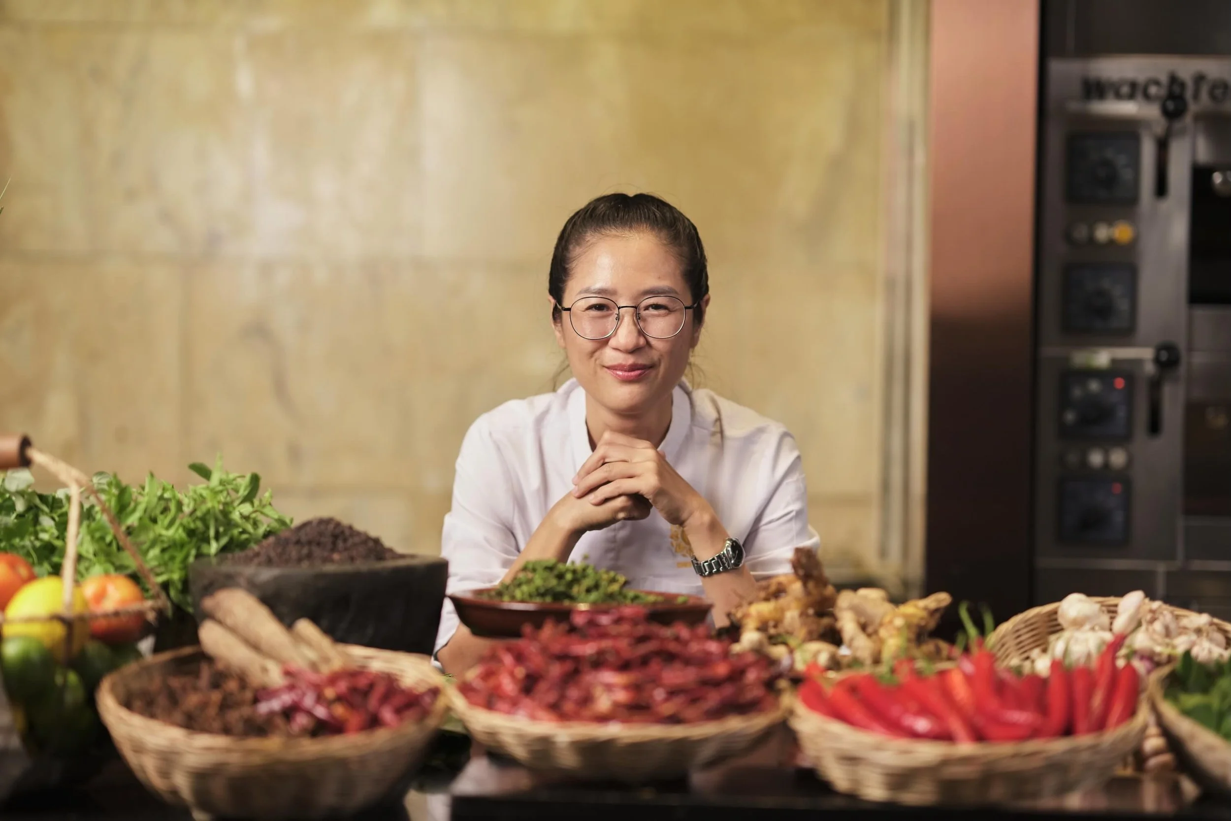 Chef Nak showcasing fresh, locally sourced Cambodian ingredients used in traditional Khmer cuisine.