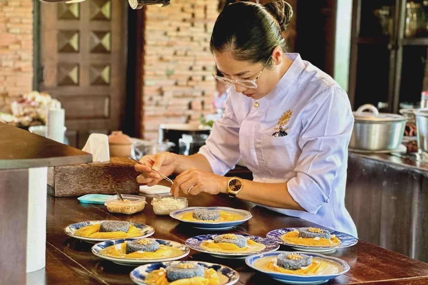 Chef Nak preparing a signature dish for guests at her Cambodian home dining experience