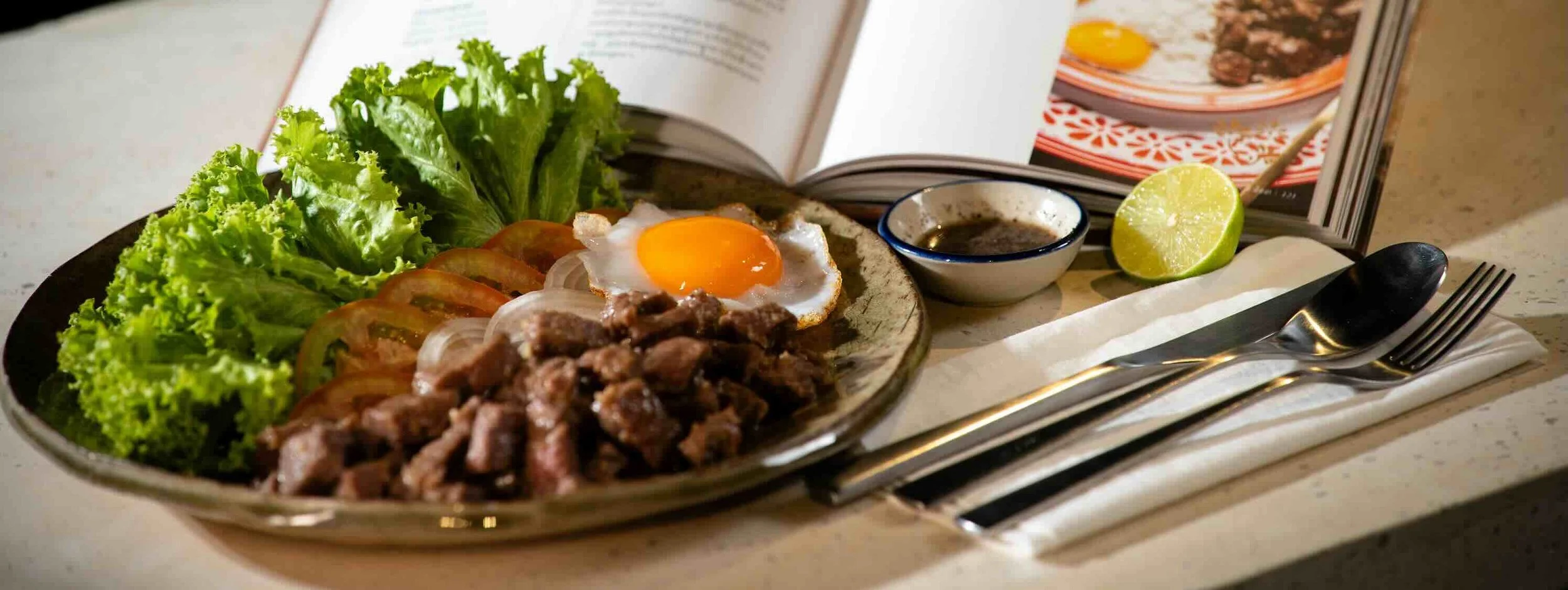 Cambodia’s beloved beef lok lak, prepared by Chef Nak