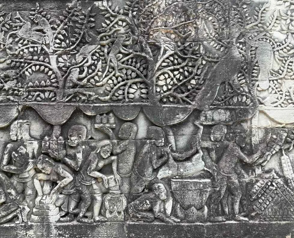 Ancient cooking activities depicted in a stone carving at Bayon Temple in Cambodia