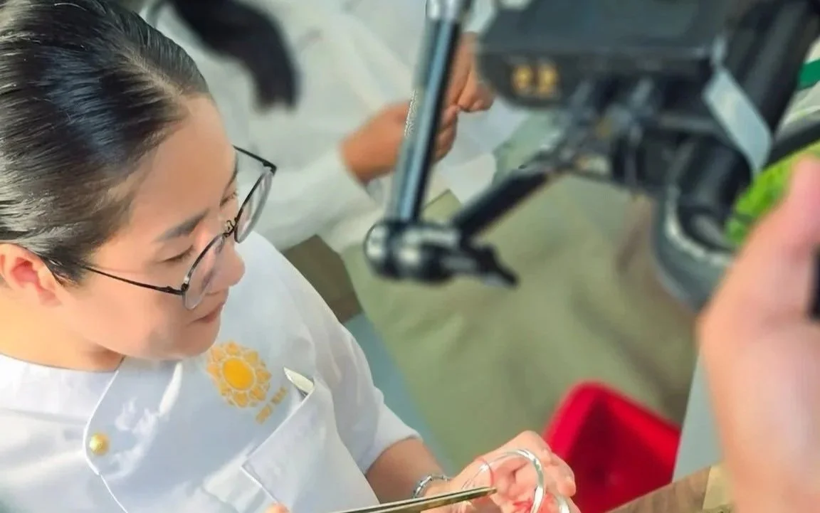 Chef Nak focusing on her garnish for a media shoot
