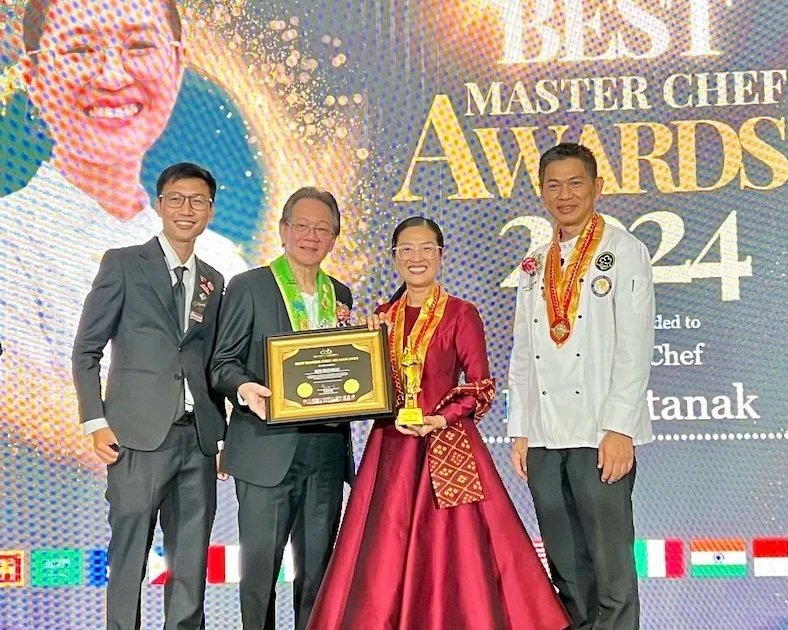 Chef Nak receiving an international award in Singapore for her contributions to Cambodian cuisine.