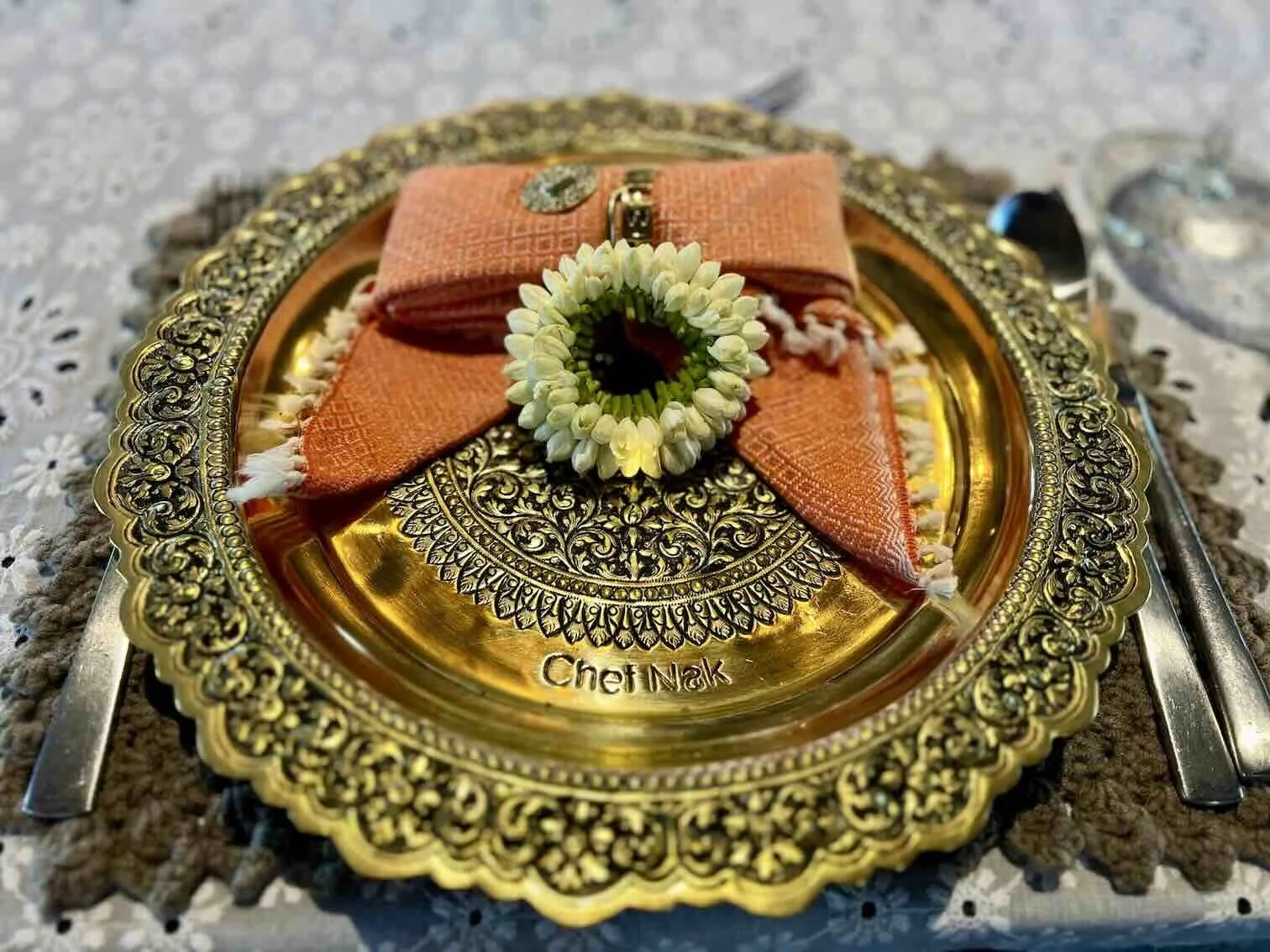 A traditional yet elegant charger plate featured in Chef Nak’s Cambodian home dining table setting.