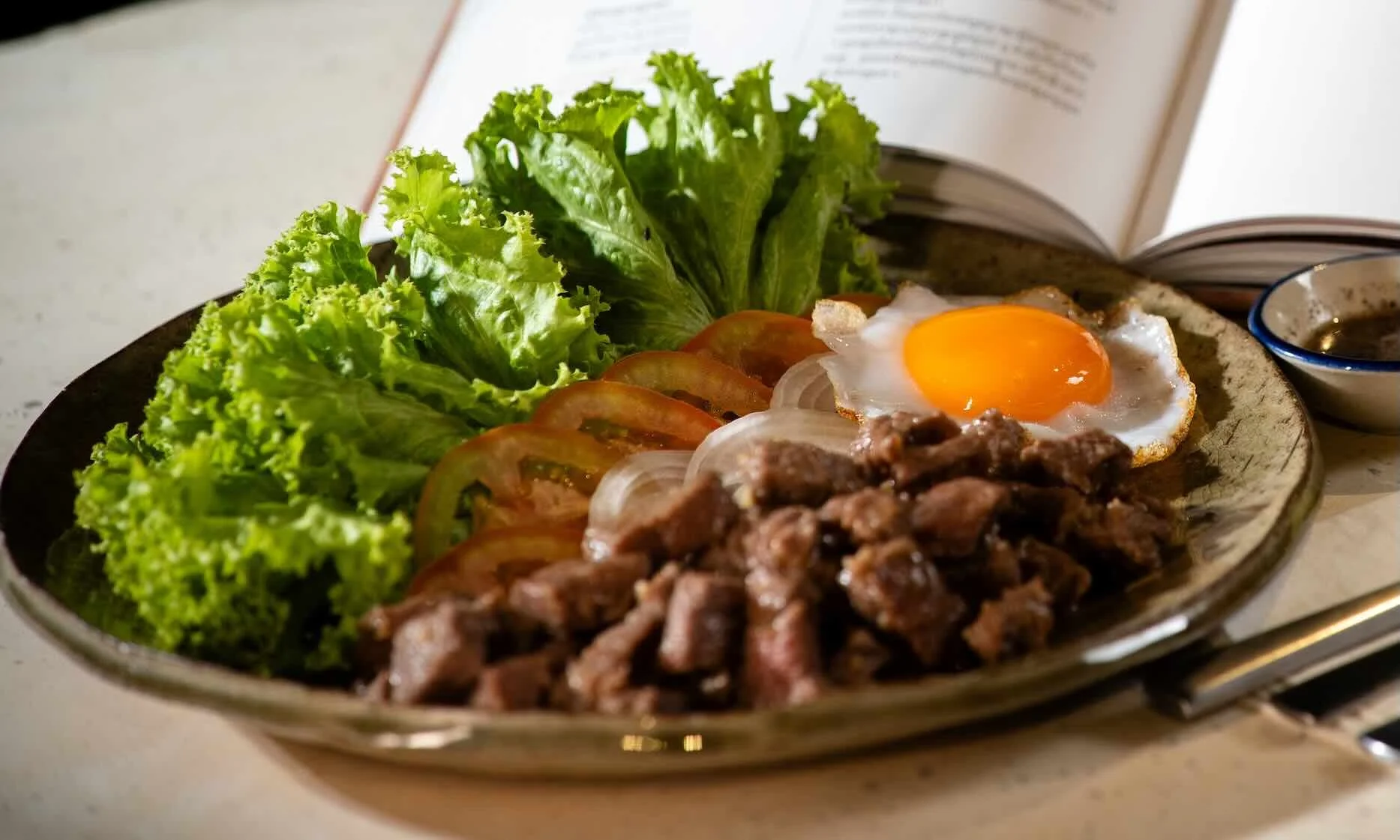 Popular Cambodian beef lok lak prepared by Chef Nak