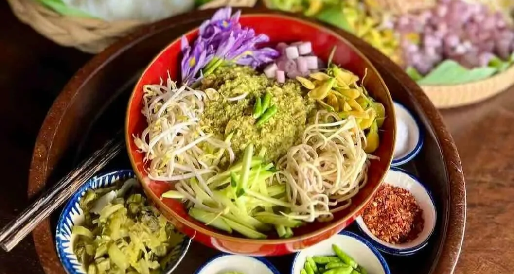 Traditional Cambodian num banh chok with fresh vegetables and a light broth