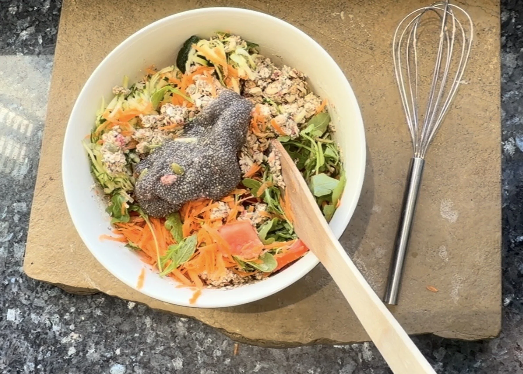 leafy greens, flakes, seeds and a thick chia gel, ready to be mixed into a vegan high-fibre vegetable loaf.