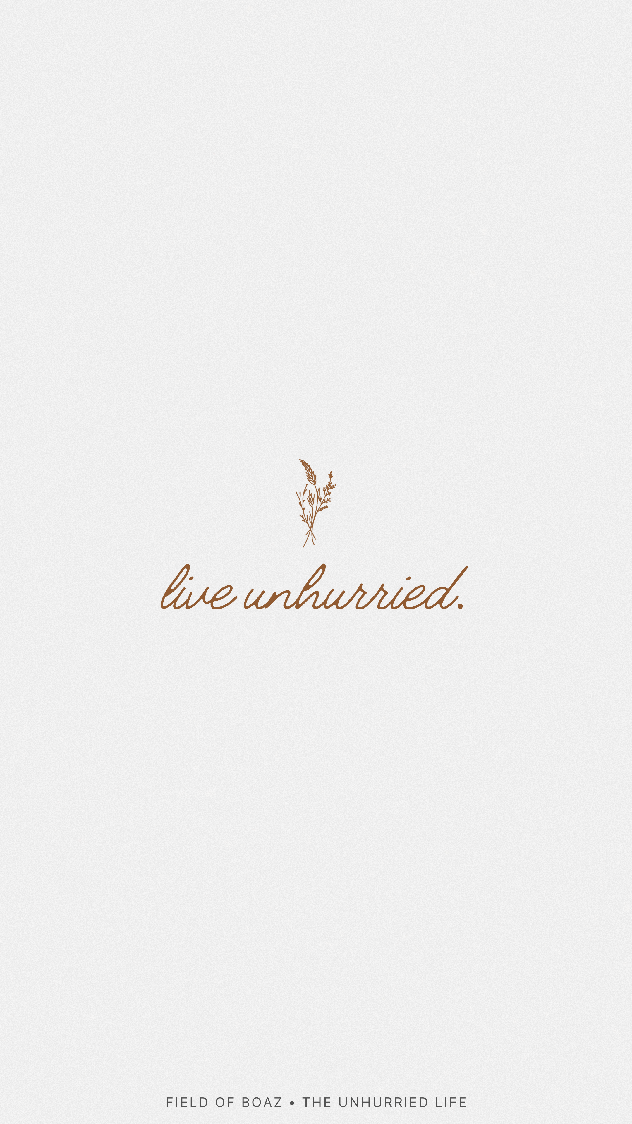 Minimalist design with a small illustration of dried grass and the phrase "live unhurried" in cursive script.