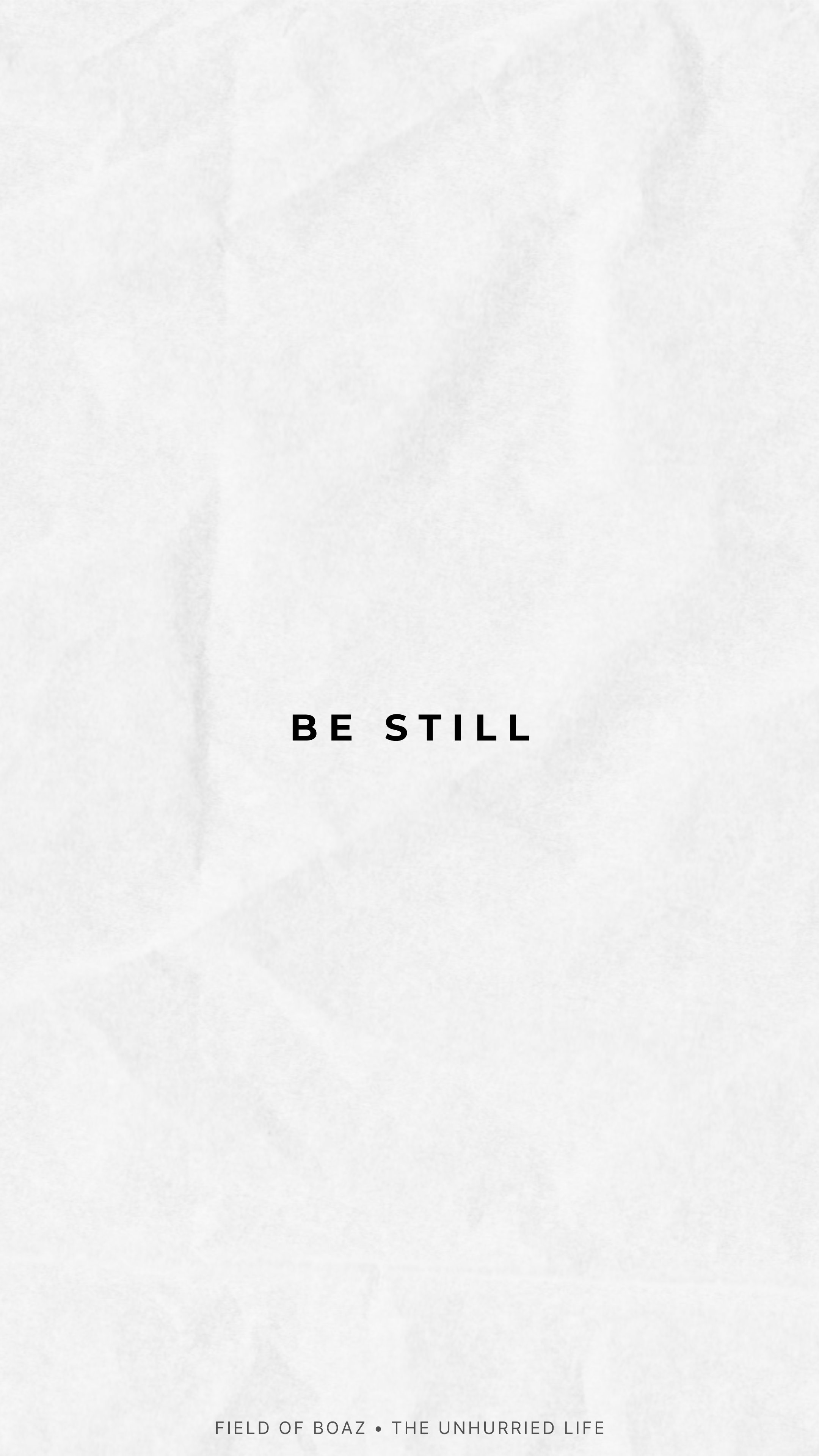 A minimalistic white page with the text 'BE STILL' in black centered in the middle. Small text at the bottom reads 'FIELD OF BOAZ • THE UNHURRIED LIFE'.