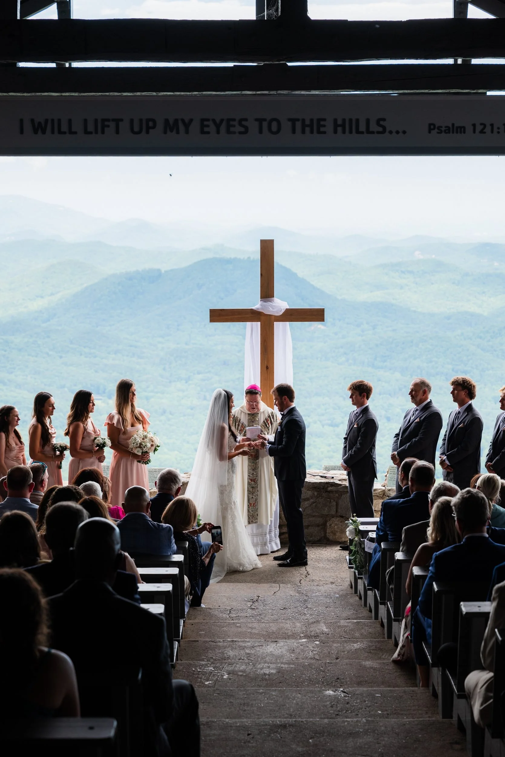 Wedding ceremony at Pretty Place Chapel with the Blue Ridge Mountains behind the cross