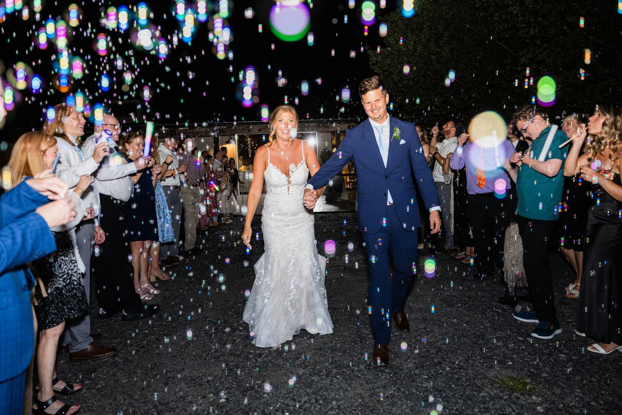 ride and groom running through a bubble and glow stick exit at Greenbrier Farms in Easley, SC