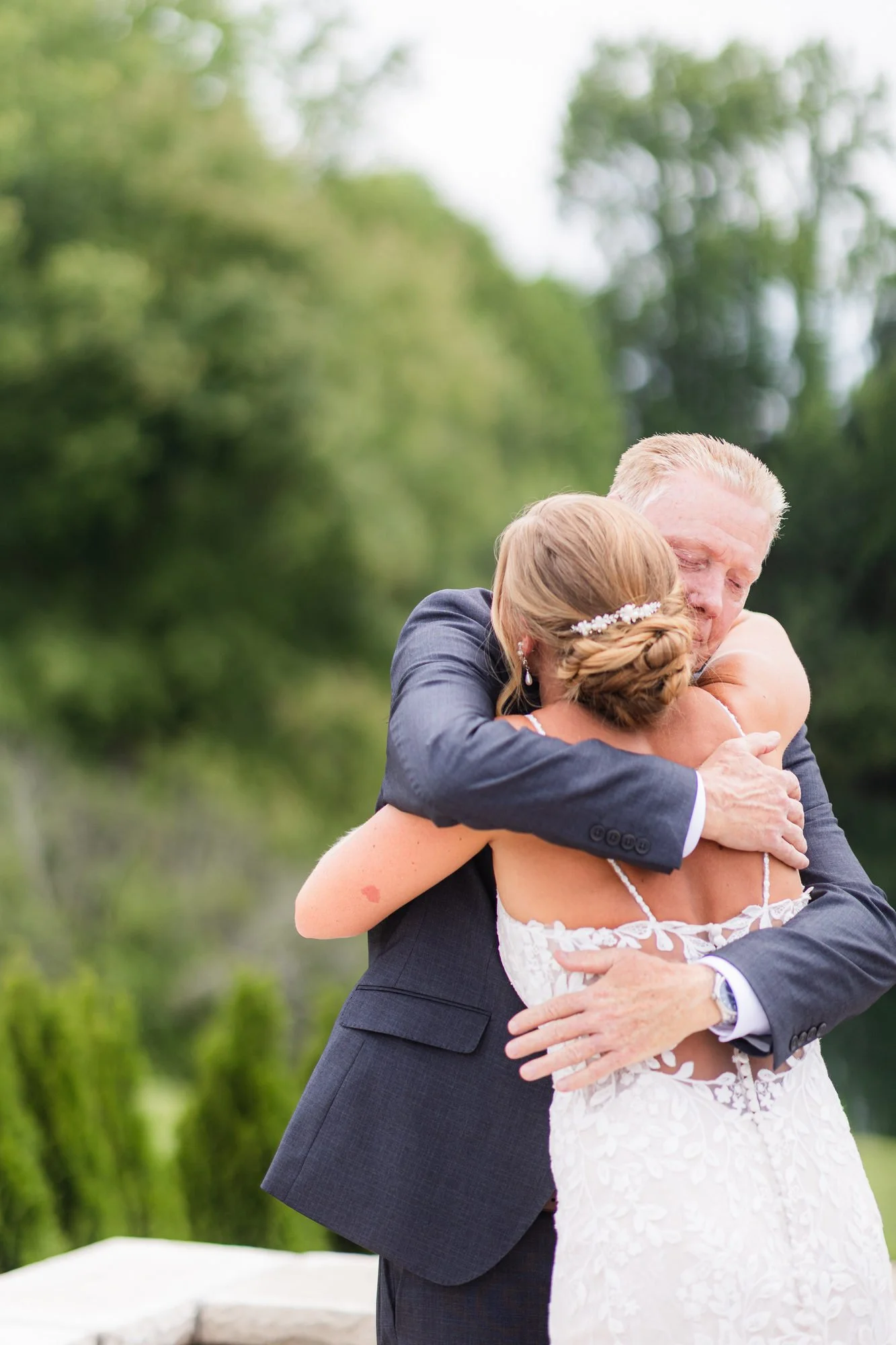 Bride hugging her dad during their father daughter first look at Greenbrier Farms
