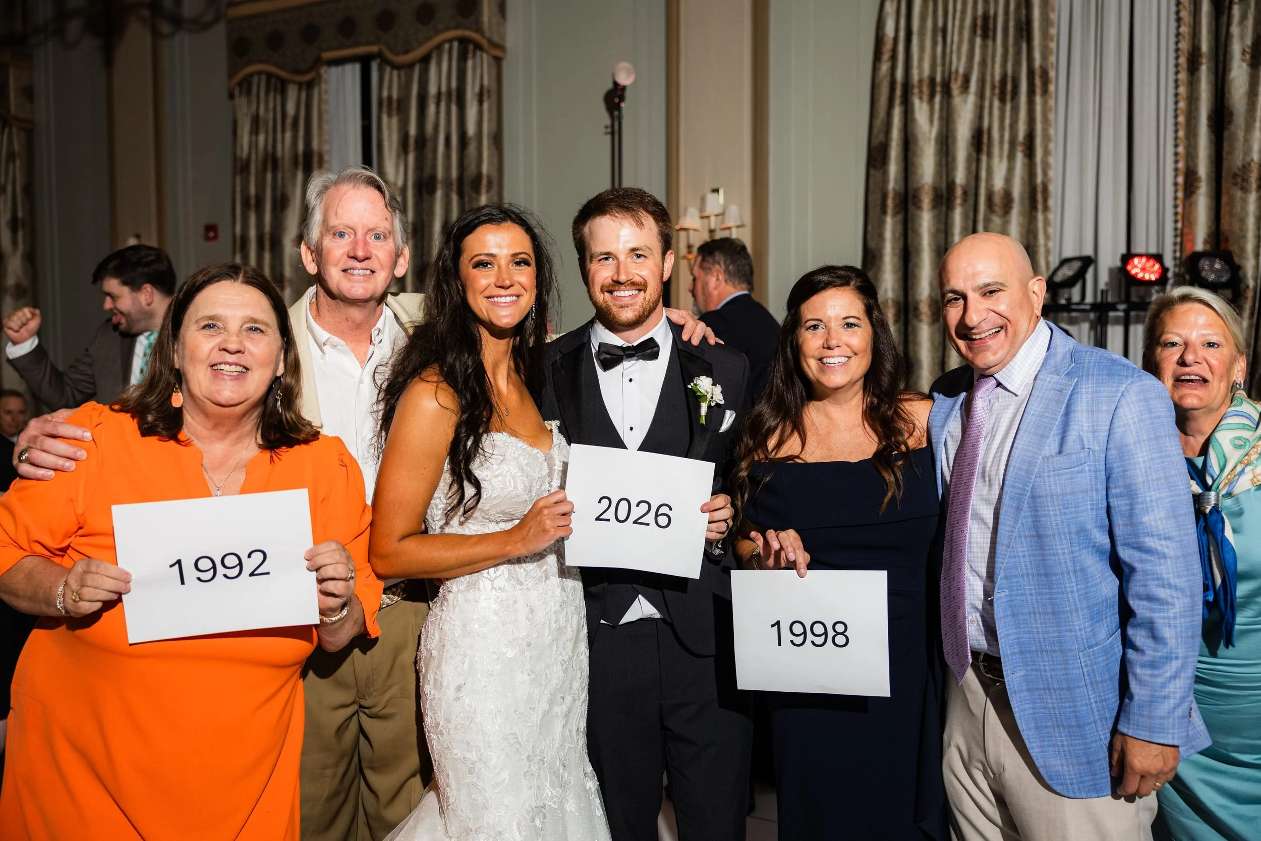 Married couples holding up their wedding years with the bride and groom at the Westin Poinsett