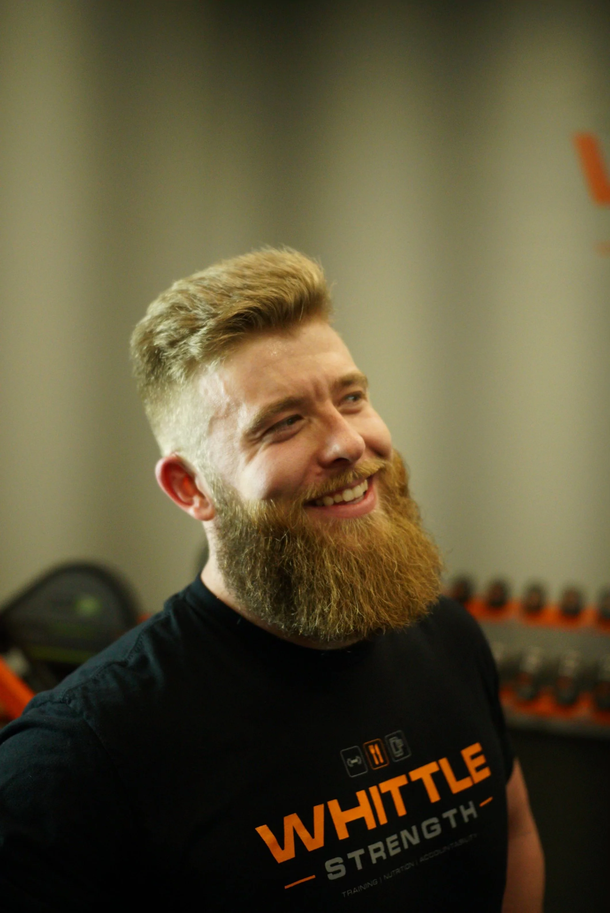 Personal trainer Shane Whittle spotting client on squat rack at WhittleStrength gym Sterling VA