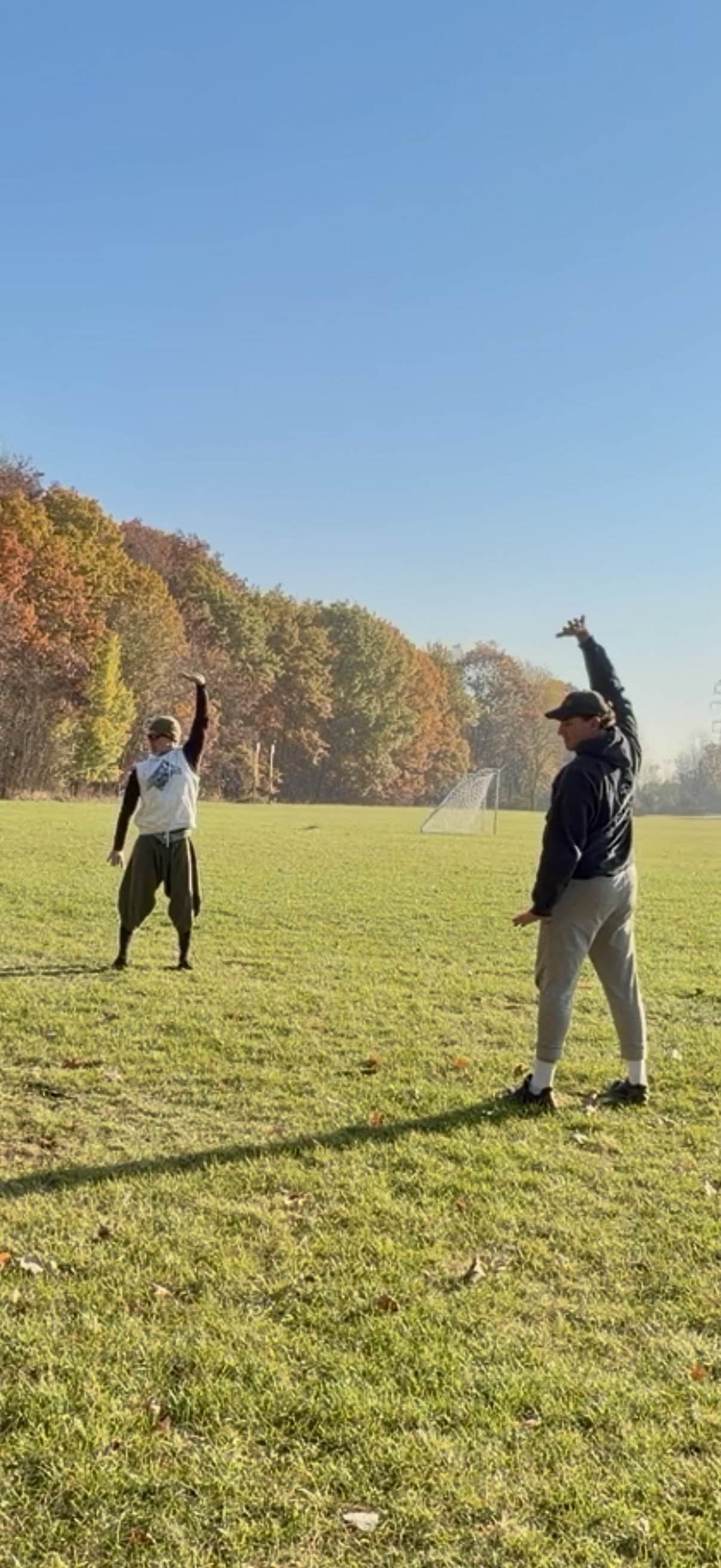 Eran Reznik and Evan -Navy SEAL practicing separate heaven and earth Qigong movement outdoors in a park