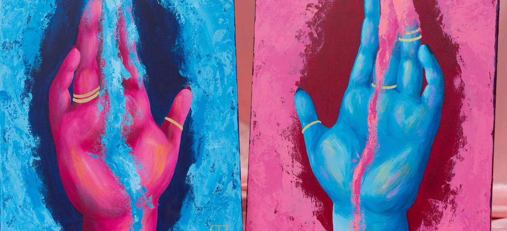 Two paintings of hands, one pink hand on a blue background and one blue hand on a pink background, each hand touching a vertical crack in the canvas.