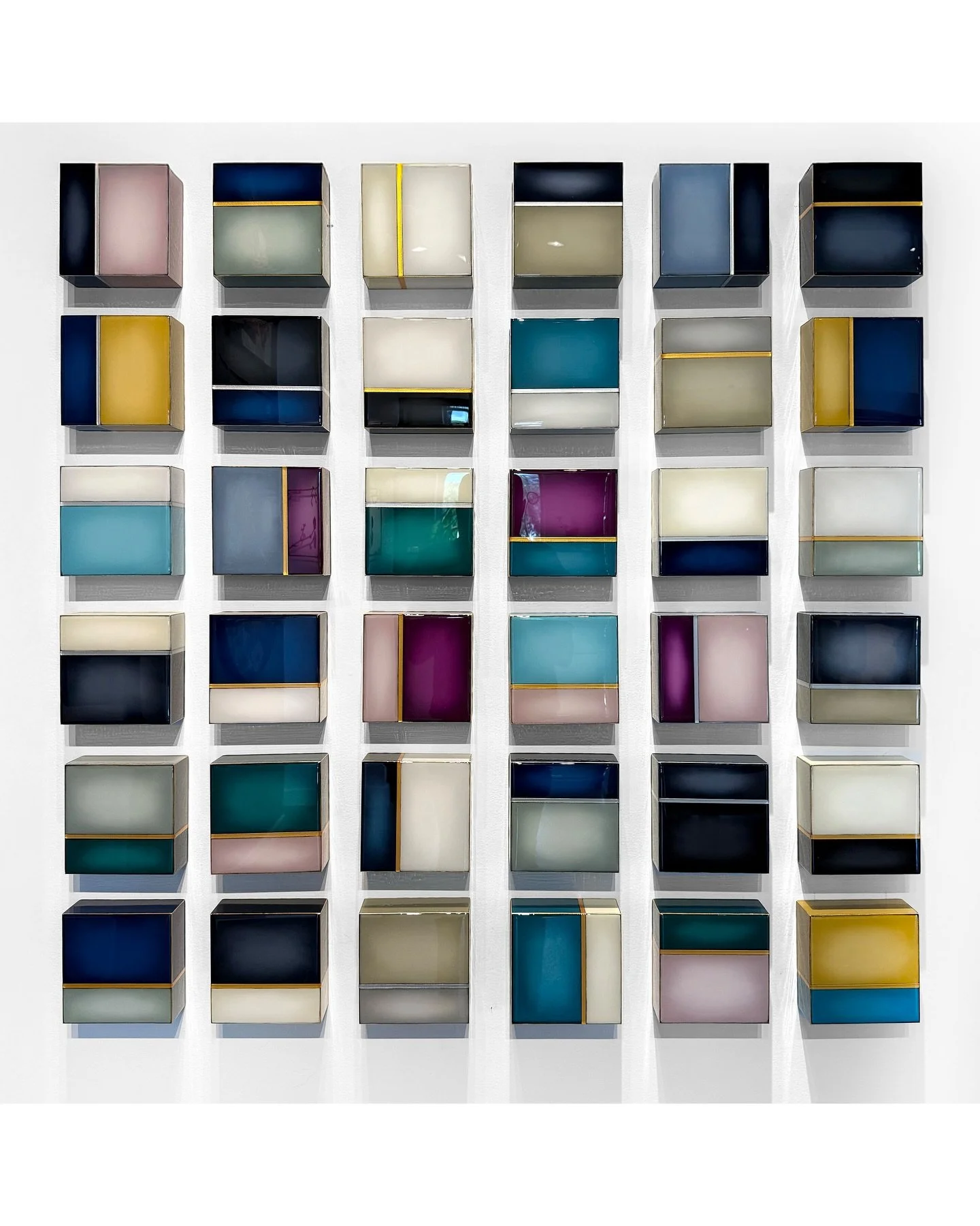 With this large grouping, I purposely limited myself to muted tones. However, I wanted to push the boundaries of muted colors and make them rich and deep; Inviting the viewer to be drawn in. 

This 36 piece resin mini grid is available at @studio_e_g