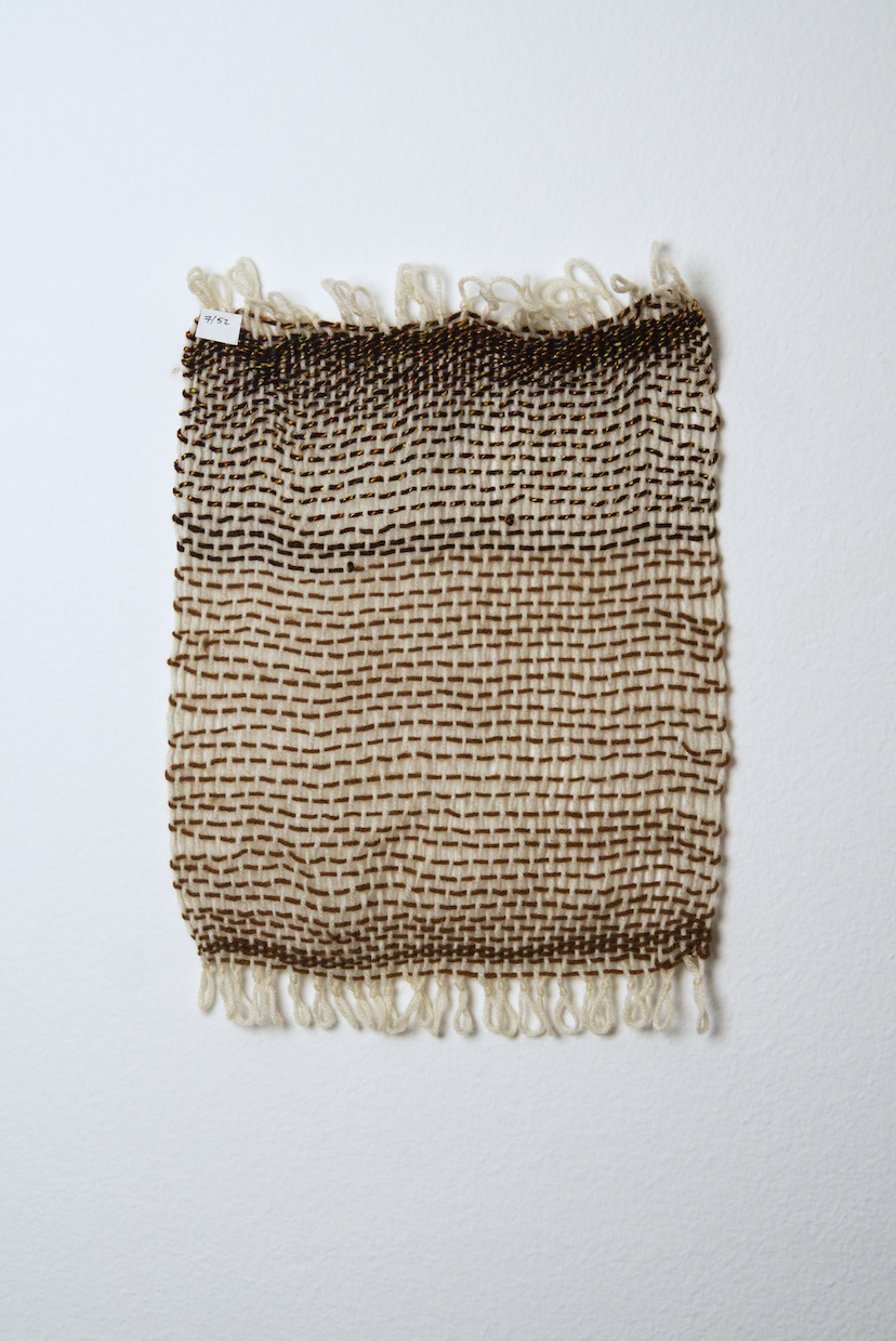 Neutral shades of white, tan, gold, brown, black and orange yarn to provide a visual record of the shift in feelings from week to week over the course of one year.
