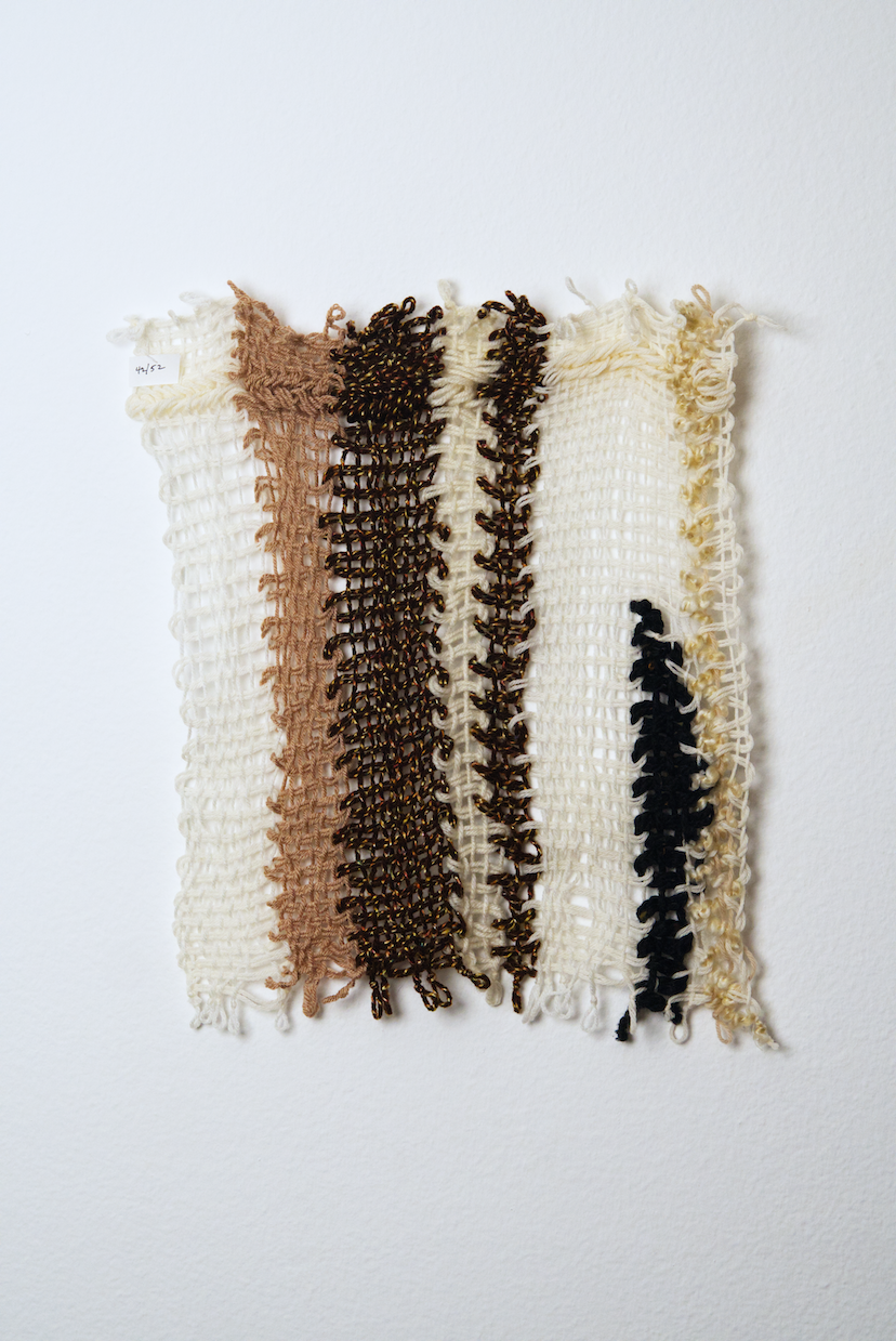 Neutral shades of white, tan, gold, brown, black and orange yarn to provide a visual record of the shift in feelings from week to week over the course of one year.
