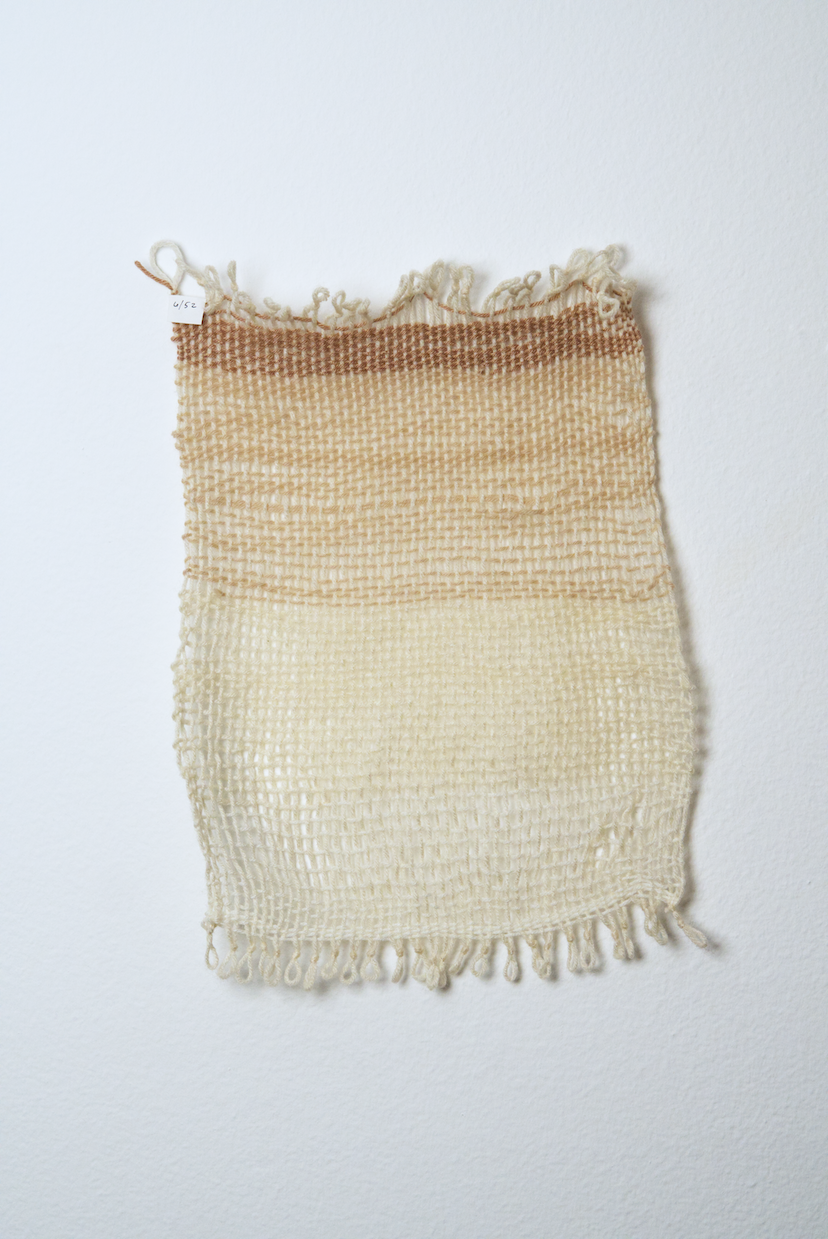 Neutral shades of white, tan, gold, brown, black and orange yarn to provide a visual record of the shift in feelings from week to week over the course of one year.