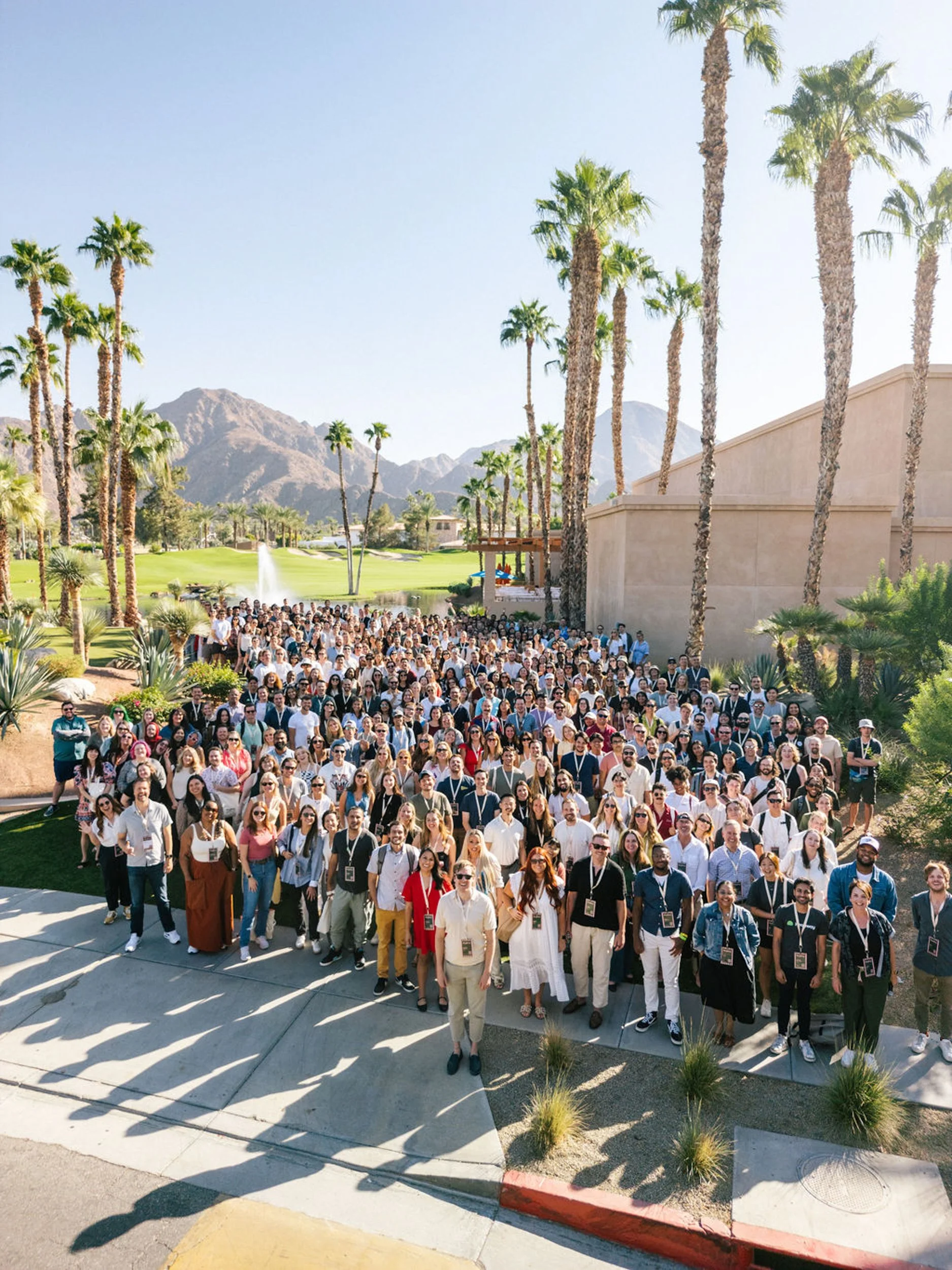 Large company group photo at a Palm Springs resort during a corporate offsite event