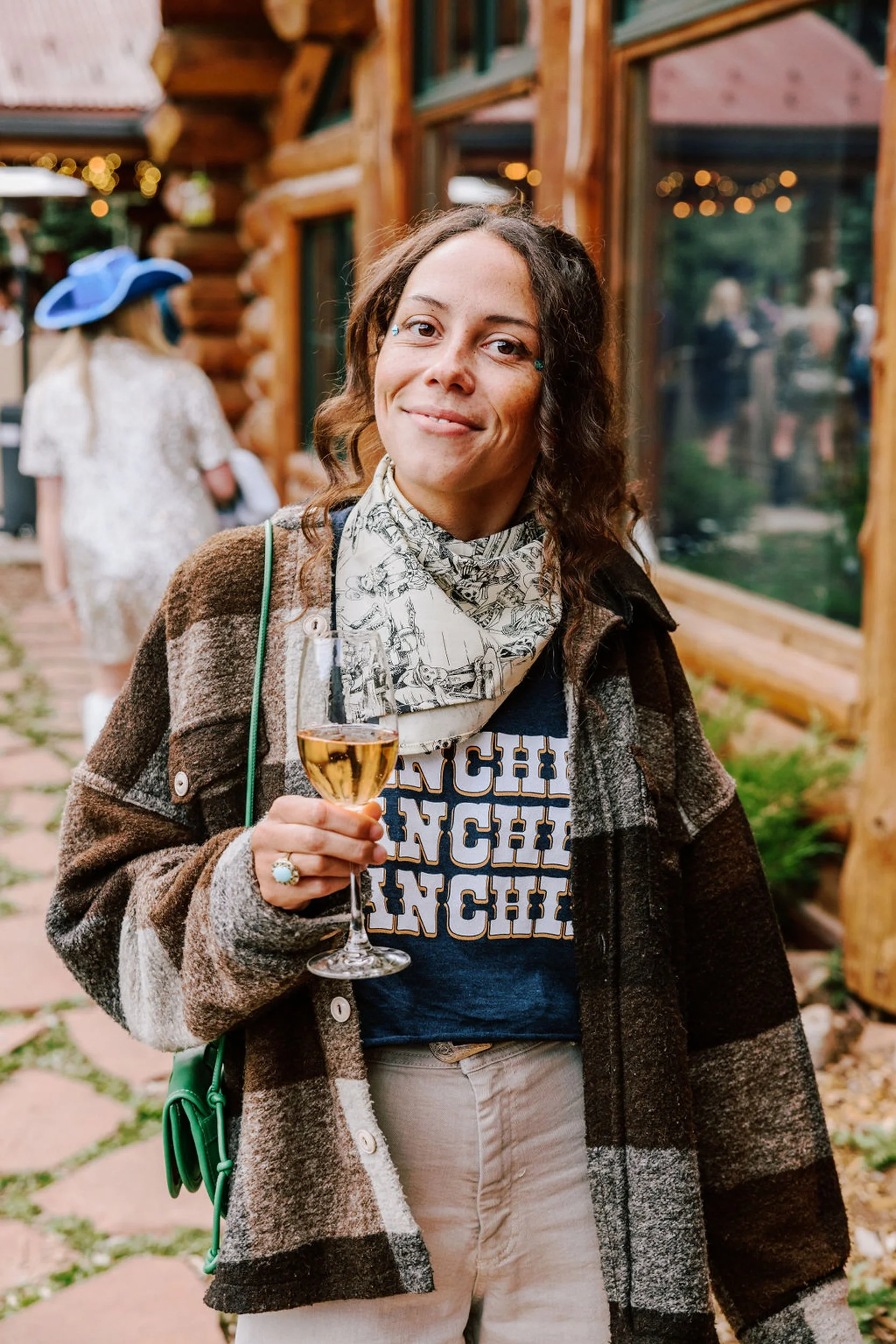 Wedding guest in plaid jacket enjoying a drink at Pine Creek Cookhouse rodeo disco reception in Aspen Colorado